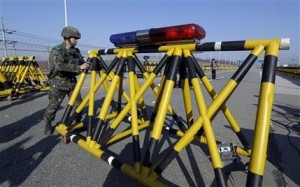Un soldado sudcoreano mueve parte de una barricada para que pasen reporteros al Puente UNificación cerca de la villa fronteriza de Panmunjom, el cual separa las dos Coreas desde la Guerra Coreana, en Paju, norte de Seúl, el miércoles 10 de abril de 2013. (Foto AP/Lee Jin-man)