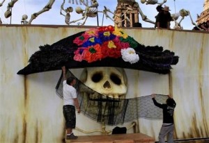 Artistas decoran una tradicional Catrina mexicana como parte de los festejos del Día de Muertos en el Zócalo de Ciudad de México el miércoles 30 de octubre de 2013. (Foto AP/Marco Ugarte)