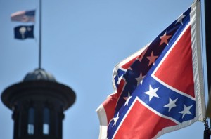 La bandera confederada se ha convertido en un símbolo que ha atraído enojo por la matanza de nueve hombres y mujeres afro americanos en la iglesia Episcopal Metodista Africana Emanuel el 18 de junio. El acusado por la matanza, el joven blanco de 21 años Dylann Roof, apareció posando con el emblema en un sitio web.