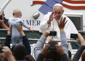 Pope Francis waves from his popemobile as he heads to celebrate mass at the conclusion of the World Meeting of Families along the Benjamin Franklin Parkway. REUTERS/Tony Gentile