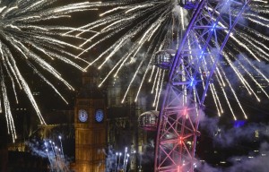 Fireworks explode around the London Eye wheel, the Big Ben clock tower and the Houses of Parliament to mark the beginning of the New Year in London, Britain, January 1, 2016. REUTERS/Toby Melville