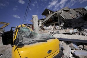 A flattened car is seen under the debris of a collapsed hotel after an earthquake struck off the Pacific coast, in Pedernales, Ecuador, April 19, 2016. REUTERS/Henry Romero
