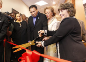 Phoenix, AZ, Dec. 3, 2009 -- Muhammad Ali continued the fight today, celebrating the launch of the nationÕs most comprehensive ParkinsonÕs disease facility. Muhammad with his wife Lonnie (right) and Linda Hunt (far right) Service Area President , CHW Arizon President asn CEO St. Joseph's Hospital cut the ribbon to open the Muhammad Ali Parkinson Center. The new $4 million Muhammad Ali Parkinson Center at the Barrow Neurological Institute in Phoenix opened today and will provide care and treatment to thousands of Parkinson patients from throughout the United States.Ê The 10,000 square foot facility is the most comprehensive ParkinsonÕs center in the nation. Physicians are expected to see about 1,600 new patients annually, double the current number and thousands more patients and their families are expected to attend one of the centerÕs numerous classes, support groups or exercise activities. The original center has drawn individuals from across the United States since it opened in 1997. Patients not only see the Muhammad Ali Parkinson CenterÕs leading neurologists, but have access to BarrowÕs renowned neurosurgeons. ÒWhen the original center opened at Barrow, we knew that we were embarking on a historic project that would change many lives,Ó said Dr. Abraham Lieberman, Director of the Muhammad Ali Parkinson Center . The expansive, state-of-the-art facility is double the size of the original center and brings together medical, rehabilitation, social and educational services and research in one location. It has been named a Center of Excellence by the National ParkinsonÕs Foundation. Along with his wife, Lonnie, other celebrities and hundreds of well wishers, Ali toured the Muhammad Ali Parkinson Center, stopping to talk and clown with the medical team. ÒMuhammad and I are delighted to share in the excitement of the grand opening of this new Center,Ó said Lonnie. ÒOur overriding goal is to help patients and their families to live full and productive live