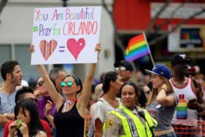 Kristen Jaeger holds a sign of remembrance for mass shooting victims in Orlando, at the 46th annual Los Angeles Gay Pride Parade in West Hollywood, California, U.S. June 12, 2016. REUTERS/David McNew