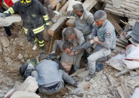 A man is rescued alive from the ruins following an earthquake in Amatrice, central Italy. REUTERS/Remo Casilli