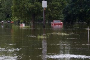 A vehicle is seen on a flooded street in Prairieville, Louisiana, U.S., August 16, 2016. REUTERS/Jonathan Bachman