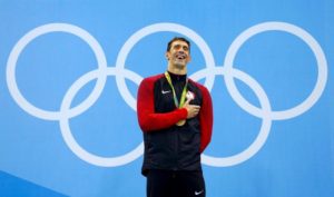 Michael Phelps poses with his gold medal REUTERS/David Gray