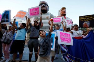 Protesters rally against Donald Trump, who is in town to speak on immigration, in Phoenix, Arizona. REUTERS/Nancy Wiechec