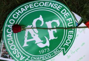 A flower is pictured over a Chapecoense soccer team logo in tribute to their players in front of the Arena Conda stadium in Chapeco, Brazil. REUTERS/Paulo Whitaker
